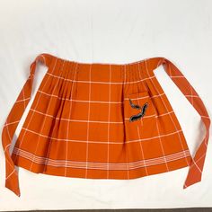 From our private collection. We are beginning to offer some of our personal items as we start to scale back for retirement. We absolutely love this orange, black & white menswear window pane plaid. The apron features a pocket that has two black bats with white top-stitching detail. We were always going to have this framed in a window box and used as a holiday decor item. Alas it never got done. But you can enjoy it as an apron or maybe finish our idea to have it framed.  WINTER GLOW.  We’ve cura Halloween Apron, Black Bat, Window Pane, Happy Holiday, Window Box, Top Stitching, Vintage Boho, White Top, White Tops