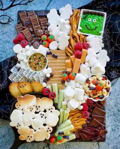 a platter filled with different types of snacks and desserts on top of each other