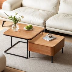 a living room with two white couches and a coffee table in front of it