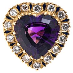 14k yellow gold ring. The spectacular vintage ring is a heart shaped motif, featuring a heart shaped faceted, dark purple color amethyst center, approximately 8.08 CTS, prong set, and decorated with a halo of alternating large round brilliant cut diamonds and navy blue enamel, approximately 0.96 TCW. The ring is finished with inlaid blue enameled foliate and dot motif decorated shoulders. Marks: 14k Dimensions: 3/4" across the top x 3/4" long Weight: 7.7 gross dwt Dark Purple Color, Heart Motif, Enamel Ring, Lorde, Vintage Heart, Yellow Gold Ring, Vintage Ring, Round Brilliant Cut Diamond, Yellow Gold Rings