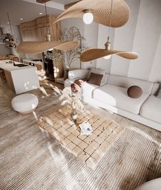 a living room filled with white furniture and lots of hanging lights over the couches