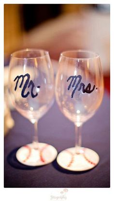 two wine glasses with the word mr and mrs painted on them sitting next to each other