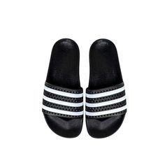 a pair of black and white adidas slides