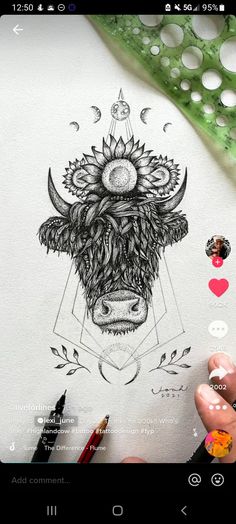 someone is drawing something with their hand on the paper and it looks like they are wearing a cow's head