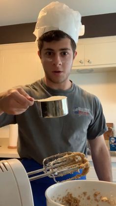 a man in a chef's hat mixing food into a bowl