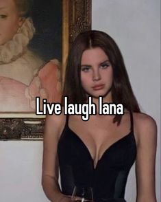 a woman standing in front of a painting with the words live laugh lana on it