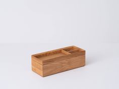 a wooden box sitting on top of a white table