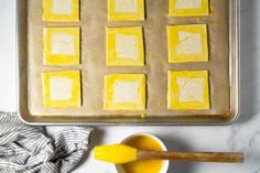 the pan is filled with squares of yellow cake batter