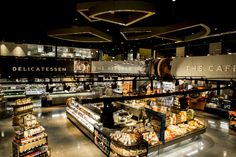 the interior of a deli filled with lots of food and condiments on display