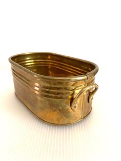 an old metal container sitting on top of a white table