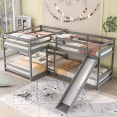 a bunk bed with slide in the middle of it next to a rug on the floor