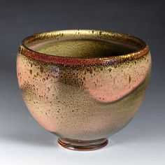 a brown and red bowl sitting on top of a table