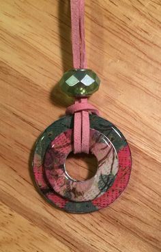 an ornament hanging from a cord on a wooden table