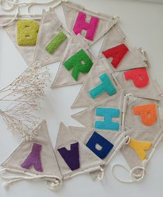 the letters are made out of felt and have been hung on a wall or ceiling