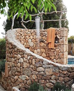 a stone wall with towels hanging on it