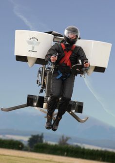 a man flying through the air while riding a parachute