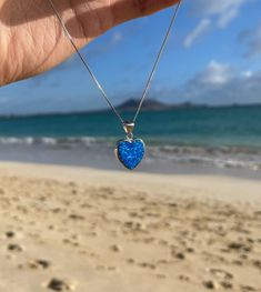 Size: 15mm Introducing our Blue Opal Heart Necklace, part of the Lanikai Blue Opal Collection. Known for its pristine Blue powdery sand, turquoise waters, and luxury homes and estates, Lanikai Beach is truly one of a kind. Just like each piece of opal, no two are alike, making each item in our collection as unique as Lanikai itself. Features: *Material: Crafted from premium 925 sterling silver for lasting shine and durability. *Gemstone: Adorned with a captivating blue opal heart that reflects t Blue Heart Cut Sterling Silver Jewelry, Blue Heart Necklace With Charm For Anniversary, Blue Heart Beads Jewelry For Anniversary, Blue Heart Cut Jewelry With Heart Charm, Blue Heart Necklace For Anniversary, Blue Open Heart Necklace For Valentine's Day, Blue Heart Charm Round Jewelry, Blue Heart Cut Necklace For Valentine's Day, Blue Heart Cut Necklace For Gift