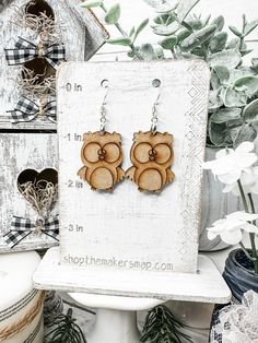 the earrings are made out of wood and have an owl design