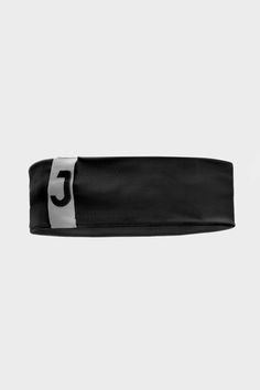 the black and white headband has a silver logo on it