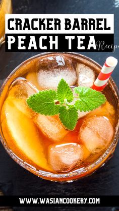 a glass filled with ice and mint on top of a black table next to a red and white striped straw