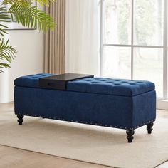 a blue ottoman sitting on top of a rug