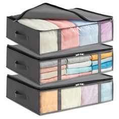 three black storage boxes with folded towels and blankets in each drawer on the bottom one is filled with multicolored sheets