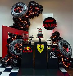 a car themed birthday party with balloons and race cars on the wall in front of it