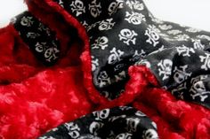 two pieces of fabric with skulls and crossbones on them, both red and black