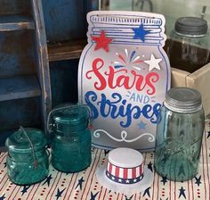 patriotic items are displayed on a table with red, white and blue stars and stripes