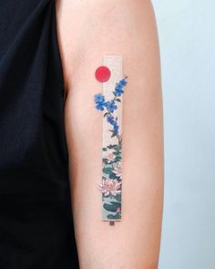 a woman's arm with a flower tattoo on the left side of her arm