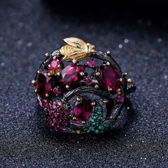 MATERIALSMain Stone: Rhodolite GarnetMain Stone Size: 4*6mmMain Stone Carat: 2.4Ct TotalSilver Weight: 6.00gRing Total Weight: 6.56gSide Stone: Nano Emerald / Created RubyMetal: 925 Sterling Silver + Gold Plated Travel Inspired Jewelry, Swiss Blue Topaz Ring, Branch Ring, Gold Bee, Laura Geller, Rhodolite Garnet, Cow Boy, Handmade Gold, Jewelry Wedding