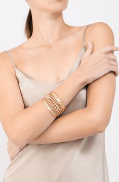 Get a trendy stacked look with this gleaming cuff bracelet finished in shiny 14-karat gold plate. 1 1/2" width 14k-gold plate Imported Modern Gold Stackable Bracelets, Gold Metal Stackable Cuff Bracelet, Gold Stackable Wrap Bracelet, Gold Stackable Wrap Bracelet Bangle, Modern Gold-tone Gold Plated Cuff Bracelet, Elegant Gold Stackable Cuff Bracelet, Elegant Gold Stackable Wrap Bracelet, Stackable Metal Cuff Bracelet For Party, Chic Yellow Gold Cuff Bracelets