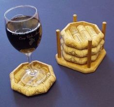 a glass of wine sitting next to some miniature coasters on top of a table