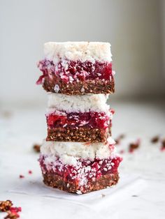 three desserts stacked on top of each other with cranberry sauce and powdered sugar