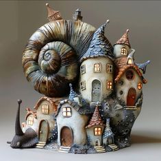 a snail is sitting on top of a house