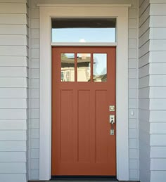 a red front door with two sidelights and a window on the top half of it