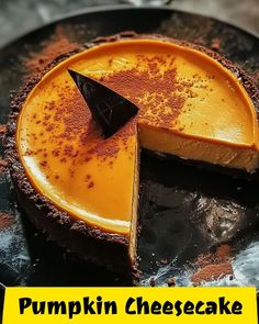 a pumpkin cheesecake on a black plate with the words pumpkin cheesecake below it