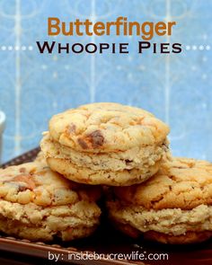 butterfingered whoopie pies stacked on top of each other in front of a cup of coffee