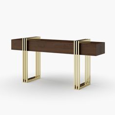 a modern console table with two brass legs and a dark wood finish on the top