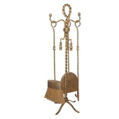 a broom and dustpan on a stand with chains