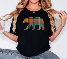 Introducing the Handmade Bear Nature Lover Shirt. Looking for a fun and real-life tee that will make you the center of attention? Look no further! Our 'Bear Nature Lover' shirt will be a hit wherever you go. It's fun and makes the perfect gift for that special bear lover in your life. We take pride in using the softest and trendiest tees to ensure comfort. This shirt is a versatile addition to anyone's wardrobe, effortlessly pairing with leggings, jeans, and shorts. Dress it up or down, and it's the perfect everyday look everyone will love. Crafted carefully, our irresistibly soft unisex tee feels like a well-loved favorite. It features a modern fit, crew neck, and short sleeves, making it stylish and comfortable. We go the extra mile to guarantee quality. All our garments are professional Black Crew Neck Top With Bear Print, Graphic Tee With Bear Print And Crew Neck, Black Casual T-shirt With Bear Print, Bar Shirt, Shorts Dress, We Bear, Fall Plaid, Bear Shirt, Bear T Shirt