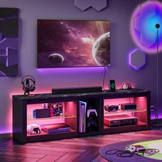 a living room with purple lighting and a large flat screen tv mounted on the wall