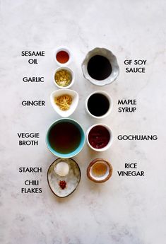 an overhead view of different sauces and condiments on a white marble surface