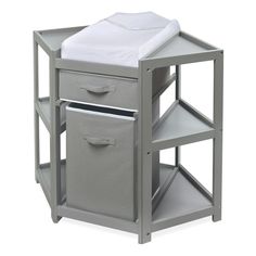 a baby changing table with two drawers and a white sheet on it's top