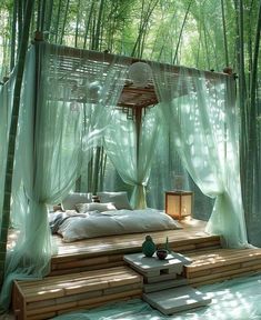 a bed in the middle of a bamboo forest with mosquito netting over it's head