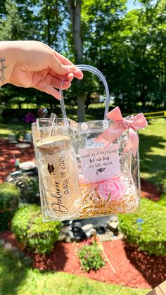 a person holding a clear bag with pink flowers in it