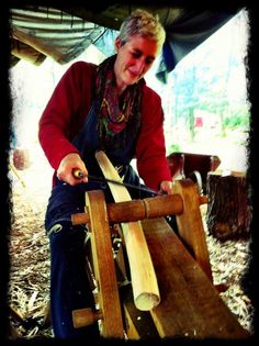 a woman is working on some wood