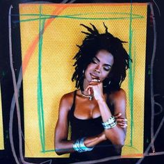 a woman with dreadlocks standing in front of a yellow and green background holding her hand to her mouth