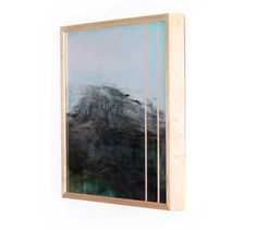 a painting hanging on the wall in front of a white wall with a wooden frame