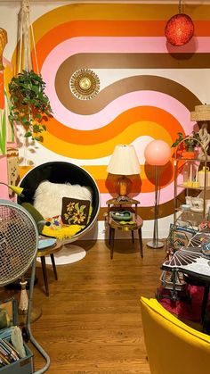 a living room filled with furniture and lots of colorful wallpaper on it's walls